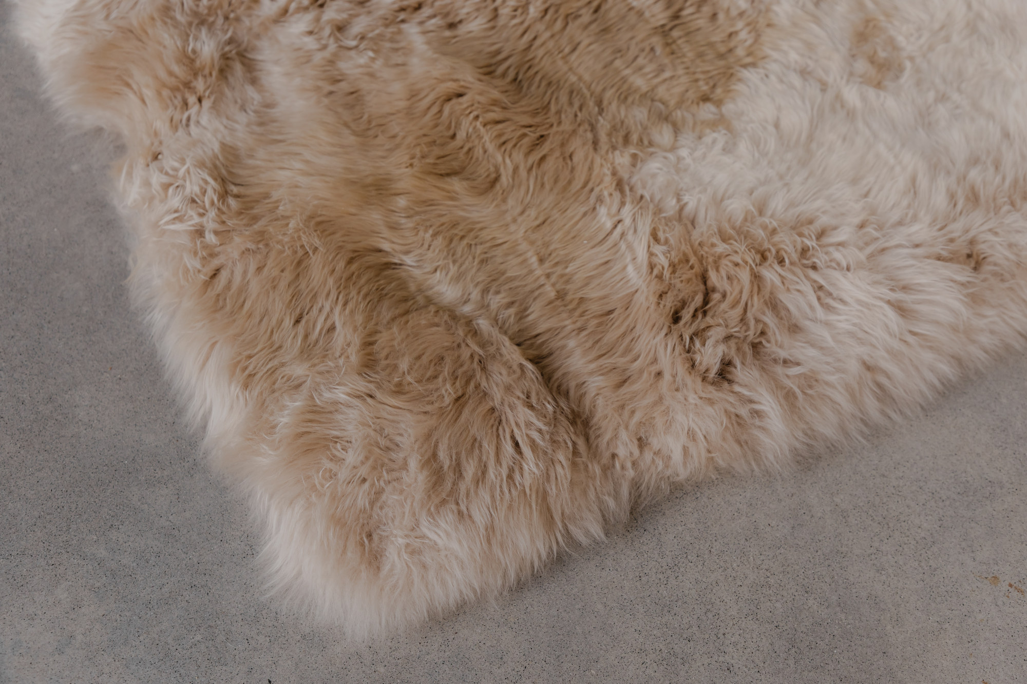 Sheepskin rug on hard floor